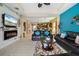 Comfortable living room featuring an electric fireplace, a ceiling fan, and seamless access to the dining and kitchen areas at 11742 Forest Park Cir, Bradenton, FL 34211