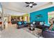Bright living room featuring modern decor, a ceiling fan, and an open concept design to the kitchen at 11742 Forest Park Cir, Bradenton, FL 34211
