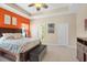 Bedroom with coastal decor, a tray ceiling, and doors to the ensuite bath and closet at 11742 Forest Park Cir, Bradenton, FL 34211