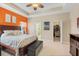Bedroom with a walk-in closet, ensuite bath, tray ceiling, and a coastal theme at 11742 Forest Park Cir, Bradenton, FL 34211