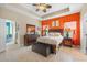 Bedroom with coastal decor, a tray ceiling, and tiled floors at 11742 Forest Park Cir, Bradenton, FL 34211