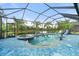 Enclosed pool and spa overlooking a peaceful lake, surrounded by lush landscaping for a private oasis at 11742 Forest Park Cir, Bradenton, FL 34211