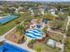 A splash pad and playground area is surrounded by mature trees and lush landscaping, providing a fun and engaging space at 11742 Forest Park Cir, Bradenton, FL 34211