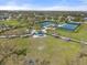 An aerial view shows amenities including tennis courts, a playground and large green spaces within the community park at 11742 Forest Park Cir, Bradenton, FL 34211