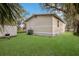Spacious backyard with healthy green grass, outbuilding, and trees at 11936 82Nd E St, Parrish, FL 34219
