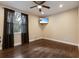 Bedroom with a ceiling fan, wood floors, and a wall-mounted television at 11936 82Nd E St, Parrish, FL 34219
