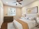 Bright bedroom with stylish furniture and decor; hardwood floor; recessed lighting; ceiling fan at 11936 82Nd E St, Parrish, FL 34219
