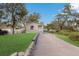 Charming single story home with inviting front yard, lush green lawn, and brick driveway at 11936 82Nd E St, Parrish, FL 34219