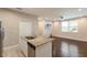 Kitchen island with stainless steel sink and dishwasher overlooking a living area at 11936 82Nd E St, Parrish, FL 34219