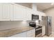 Close-up of the kitchen with stainless steel appliances and granite countertops at 11936 82Nd E St, Parrish, FL 34219