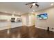 Open-concept living room featuring dark wood floors and a modern kitchen with granite countertops at 11936 82Nd E St, Parrish, FL 34219