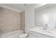 Bright bathroom with a tiled shower, bathtub, and white vanity, enhancing the spa-like feel at 12180 Wellen Golf St # 302, Venice, FL 34293
