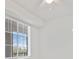 Bright bedroom featuring a window with blinds, modern ceiling fan, and light fixture, enhancing the room's appeal at 12180 Wellen Golf St # 302, Venice, FL 34293