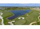 Scenic aerial view of the golf course, featuring a large lake and manicured greens at 12180 Wellen Golf St # 302, Venice, FL 34293