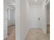 Hallway featuring tile flooring and access to a bedroom, showcasing the home's layout at 12180 Wellen Golf St # 302, Venice, FL 34293