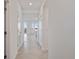 Bright hallway with tile flooring leading to the living area and offering ample closet space at 12180 Wellen Golf St # 302, Venice, FL 34293