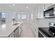 Well-lit kitchen with a large island, modern appliances, and white cabinetry, ideal for cooking at 12180 Wellen Golf St # 302, Venice, FL 34293