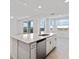 Open-concept living space with kitchen island, ample natural light, and modern finishes at 12180 Wellen Golf St # 302, Venice, FL 34293