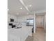 Bright kitchen featuring stainless appliances, an island, and white cabinetry at 12180 Wellen Golf St # 302, Venice, FL 34293