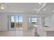Bright living area with an open floor plan, balcony access, and a kitchen island at 12180 Wellen Golf St # 302, Venice, FL 34293