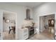 Well-lit kitchen with stainless steel appliances, white cabinets, and views of the dining and living room at 13600 N Branch Rd, Sarasota, FL 34240