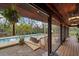 Exterior pool patio area with seating and outdoor hanging plants at 13600 N Branch Rd, Sarasota, FL 34240