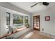 Relaxing sitting area with a bay window overlooking the pool and a stylish wooden door at 13600 N Branch Rd, Sarasota, FL 34240