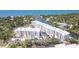 A high-angle view shows the condos and community on the waterfront, nestled among trees and a canal at 1709 N Tamiami Trl # 422, Sarasota, FL 34234