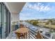 Inviting balcony features a table set with a picturesque view overlooking the serene canal and boat docks at 1709 N Tamiami Trl # 422, Sarasota, FL 34234
