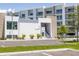 Exterior shot of clubhouse featuring modern architecture, lush landscaping, and convenient parking spaces at 1709 N Tamiami Trl # 422, Sarasota, FL 34234