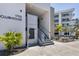Modern clubhouse with elevator and stairs surrounded by well-maintained landscaping and modern architectural elements at 1709 N Tamiami Trl # 422, Sarasota, FL 34234