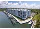 Exterior of waterfront condos featuring private boat slips and docks, a kayak launch, and covered parking at 1709 N Tamiami Trl # 422, Sarasota, FL 34234