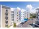 Exterior view of the condo buildings featuring balconies, covered parking, and parking spaces at 1709 N Tamiami Trl # 422, Sarasota, FL 34234