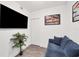 Inviting room features television, blue couch, and a neutral color scheme at 1709 N Tamiami Trl # 422, Sarasota, FL 34234