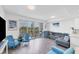 Bright living room with wood floors, comfortable seating, and a large sliding glass door leading to the balcony at 1709 N Tamiami Trl # 422, Sarasota, FL 34234
