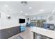 Well-lit living space with island seating, beach themed artwork, sliding doors to the balcony, and stylish furnishings at 1709 N Tamiami Trl # 422, Sarasota, FL 34234