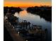 Waterfront view at sunset showcasing the community's boat docks and the serene coastal environment at 1709 N Tamiami Trl # 422, Sarasota, FL 34234