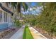 Wide driveway with landscaped median leads to this blue house and its attached garage at 1744 South Dr, Sarasota, FL 34239