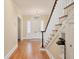 Welcoming foyer with gleaming hardwood floors, staircase, and charming vintage telephone at 1744 South Dr, Sarasota, FL 34239