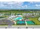 Aerial view of community amenities, featuring a pool, playground, tennis courts, and nearby residential homes at 17842 Cherished Loop, Bradenton, FL 34211