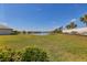 Scenic backyard featuring a lush green lawn and tranquil lake views, creating a serene and picturesque setting at 17842 Cherished Loop, Bradenton, FL 34211