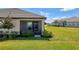 Spacious backyard featuring a screened lanai, lush greenery, and a well-maintained lawn, perfect for outdoor activities at 17842 Cherished Loop, Bradenton, FL 34211