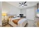 Cozy bedroom featuring a comfortable bed, neutral decor, and a convenient desk area for work or study at 17842 Cherished Loop, Bradenton, FL 34211