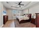 Cozy primary bedroom featuring a ceiling fan, plush carpet, and lots of natural light at 17842 Cherished Loop, Bradenton, FL 34211