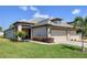 Charming single-story home showcasing a well-manicured lawn and a two-car garage at 17842 Cherished Loop, Bradenton, FL 34211