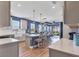 Bright, open kitchen showcasing a large island with seating, modern appliances, and hardwood floors at 17842 Cherished Loop, Bradenton, FL 34211