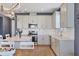 Bright kitchen featuring white cabinetry, stainless steel appliances, and a stylish tile backsplash at 17842 Cherished Loop, Bradenton, FL 34211