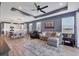 Relax in this open-concept living space with a ceiling fan, kitchen view and comfortable furniture at 17842 Cherished Loop, Bradenton, FL 34211