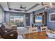 Relaxing living room features a ceiling fan, and sliding glass doors leading to the outdoor patio at 17842 Cherished Loop, Bradenton, FL 34211