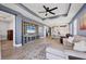 Open-concept living space boasts comfortable seating, entertainment center, and seamless flow into the kitchen at 17842 Cherished Loop, Bradenton, FL 34211